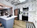 Updated kitchen with stainless steel appliances, subway tile backsplash, white cabinets, and a breakfast bar at 120 Williamsburg Way, Fayetteville, GA 30214