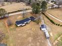 Expansive property with home, detached garage, camper, firepit, and treelined border at 4739 Lower Jersey Rd, Oxford, GA 30054