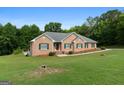 Beautiful brick home with green shutters, landscaping, and a well-maintained lawn at 604 Clearwater Ct, Mcdonough, GA 30252