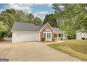 Well-maintained home featuring a two-car garage, brick detailing, and manicured landscaping at 70 Summer Walk Dr, Covington, GA 30016
