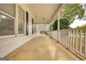 Inviting covered porch with swing and white railing, perfect for relaxing outdoors at 70 Summer Walk Dr, Covington, GA 30016