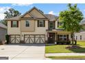 Attractive home with a three-car garage, stone accents, lush lawn, and an inviting front porch at 71 Pacific Ave, Sharpsburg, GA 30277