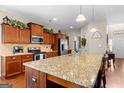 Spacious kitchen featuring granite countertops, stainless steel appliances, and ample wooden cabinet space at 71 Pacific Ave, Sharpsburg, GA 30277