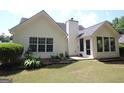 A home featuring a well-maintained backyard with a patio and ample green space at 300 Cloverwood Dr, Fayetteville, GA 30215