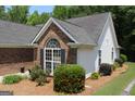 A well-maintained home featuring lush landscaping and a blend of brick and siding at 300 Cloverwood Dr, Fayetteville, GA 30215