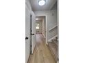 Inviting hallway with wood-look flooring and access to a carpeted staircase at 1102 Tony Valley Se Dr, Conyers, GA 30013