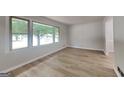 Bright living room with large windows and neutral wall colors, complemented by modern floors at 1102 Tony Valley Se Dr, Conyers, GA 30013