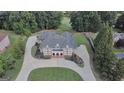 Stunning aerial view of a grand brick home with mature landscaping and circular driveway at 205 Somerset Ct, Mcdonough, GA 30253