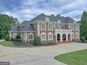 Beautiful two-story brick home with elegant landscaping, circular driveway and a classic architectural design at 205 Somerset Ct, Mcdonough, GA 30253