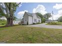 Home with a side view with a gravel drive and a beautiful leafy tree in the front yard at 111 S Old 27, Roopville, GA 30170