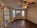 Cozy living room featuring a ceiling fan, wood floors, and bright natural lighting at 257 Juliet Dr, Hampton, GA 30228