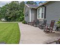 Exterior view of a home with rocking chairs on a concrete patio at 105 Greenfield Cir, Fayetteville, GA 30215