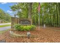Community entrance sign for 'The Highlands' surrounded by a wooded area at 105 Gleneagles Pt, Peachtree City, GA 30269