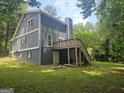 Spacious backyard featuring a large deck and lush greenery, perfect for outdoor entertaining and relaxation at 686 Favorwood Sw Dr, Marietta, GA 30060