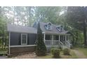 Inviting home showcasing a covered porch, mature landscaping, and classic architectural details at 686 Favorwood Sw Dr, Marietta, GA 30060