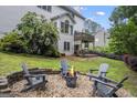 Outdoor oasis featuring a fire pit with Adirondack chairs and a lush garden at 3924 Lorien Nw Way, Kennesaw, GA 30152