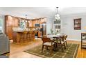 Open-concept kitchen and dining area with a center island, stainless steel appliances, and hardwood floors at 3571 Lake Se Dr, Smyrna, GA 30082