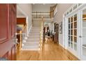Grand two-story foyer with hardwood flooring and a staircase leading to the second level of the home at 3823 Heritage Pl, Buford, GA 30519