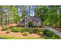 Traditional home with a landscaped yard, a cozy design, and mature trees at 226 Le Paradis Blvd, Sharpsburg, GA 30277