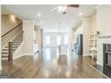Open floorplan featuring hardwood floors connecting the living room, kitchen, and dining area perfect for modern living at 1106 Bakary Ct, Decatur, GA 30032