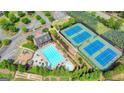 Aerial view of community pool, clubhouse, tennis courts, and playground at 1370 Sunnys Halo Dr, Suwanee, GA 30024