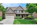 Beautiful two-story brick home with a well-manicured lawn at 1370 Sunnys Halo Dr, Suwanee, GA 30024