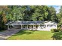 Inviting covered porch featuring stylish hanging plants and fresh landscaping at 4353 White Oak Dr, Sugar Hill, GA 30518