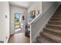 Inviting entryway featuring wood flooring, a staircase, and an open door with a view of the well-maintained front yard at 1003 Nandina Ct, Villa Rica, GA 30180