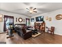 Spacious living room featuring hardwood floors, a large TV, comfortable seating, and decor that creates a cozy atmosphere at 1003 Nandina Ct, Villa Rica, GA 30180