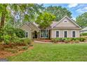 Inviting single-story home with lush landscaping, stone accents, and a well-maintained front yard at 229 Terrane Rdg, Peachtree City, GA 30269