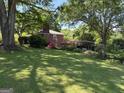 Picturesque backyard featuring a large grassy area and convenient covered parking at 2942 Old Norcross Rd, Tucker, GA 30084