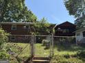 Backyard view featuring a privacy fence, outdoor lighting, and raised screen porch at 2942 Old Norcross Rd, Tucker, GA 30084