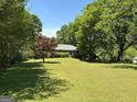 Expansive front yard with mature trees and a well-maintained lawn enhances curb appeal at 2942 Old Norcross Rd, Tucker, GA 30084