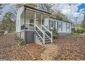 Inviting home showcasing a classic design with a covered porch and updated gray trim at 1865 Broadwell Sw St, Atlanta, GA 30310