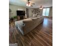 Spacious living room featuring hardwood floors, ceiling fans, and large windows at 220 Jackson Rd, Mcdonough, GA 30252