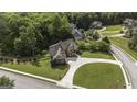 Aerial view of a luxurious home nestled in a lush, green neighborhood with mature trees and manicured lawns at 9742 Fallview Ct, Villa Rica, GA 30180