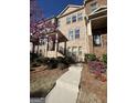Brick townhome with a walkway, front yard landscaping, and flowering trees at 3608 Davenport Rd, Duluth, GA 30096
