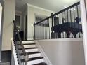 View of the home's staircase with dark wood banisters and gray walls at 3608 Davenport Rd, Duluth, GA 30096
