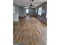 Spacious living room features hardwood floors, neutral paint, and multiple windows for lots of natural light at 957 Astor Ave, Forest Park, GA 30297