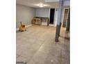 Spacious room with tile flooring, offering a functional sink area, and utility connections at 957 Astor Ave, Forest Park, GA 30297