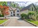 Attractive two-story home showcases a sprawling driveway, verdant landscaping, and established trees at 1214 Weatherstone Way, Peachtree City, GA 30269