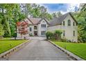 Beautiful two-story home with a long driveway, well-maintained landscaping, and surrounded by mature trees at 1214 Weatherstone Way, Peachtree City, GA 30269