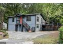 Exterior view of the home featuring a deck and staircase at 1772 Martin Se Pl, Smyrna, GA 30080