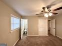 Cozy bedroom with carpeted floors, a ceiling fan, and a glimpse into an attached bathroom at 2860 Lynda Pl, Decatur, GA 30032