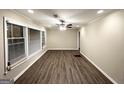 Bright living room with hardwood floors, a ceiling fan, and plenty of natural light from large windows at 2860 Lynda Pl, Decatur, GA 30032