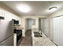 The kitchen features modern appliances, a stainless steel fridge, and granite countertops at 614 Tramore Ct, Stockbridge, GA 30281