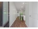 Inviting foyer with hardwood floors leading into an open-concept living area with a modern kitchen and natural light at 385 Orchard Land, Covington, GA 30014