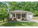 Attractive single-story home with a cozy front porch, tidy landscaping, and an attached one car garage at 385 Orchard Land, Covington, GA 30014