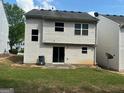 View of the home's backyard with a grassy lawn and a patio area at 9515 Lakeview Rd, Union City, GA 30291