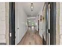 Grand entryway featuring hardwood floors, decorative lighting, and a welcoming open floor plan at 5350 Woodline View Cir, Hoschton, GA 30548
